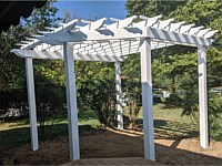 <b>Free Standing White Vinyl Pergola sitting next to a Trex Transcend Havana Gold Deck</b>